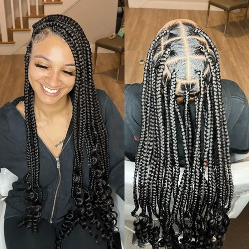 Medium thick Coi Leray Braids with a classic middle part