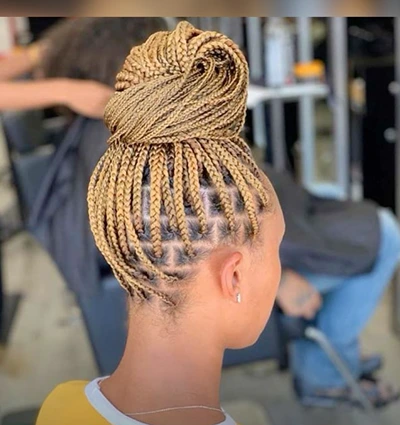 blonde knotless braids in a bun